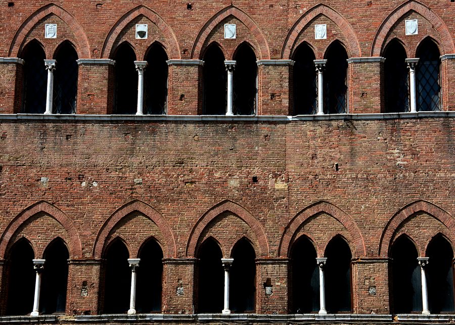 Rectangular bricks and Gothic arches: architectural symbols of Siena, Italy.