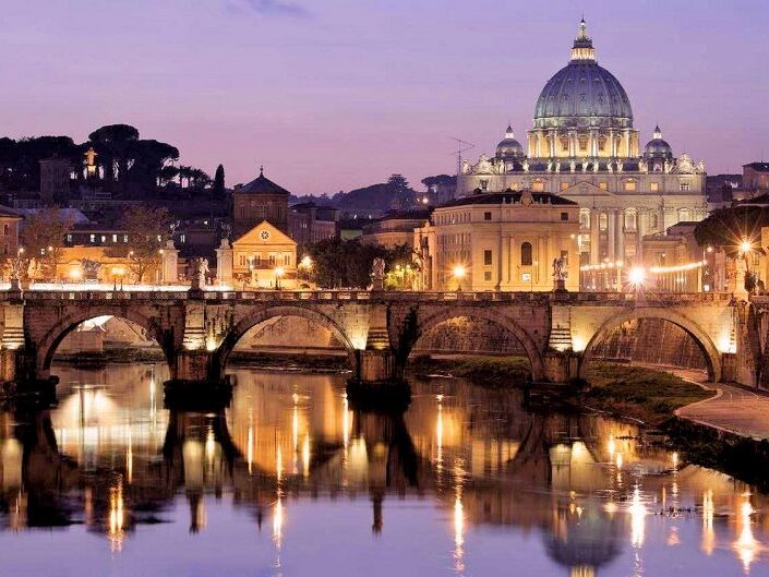 Vatican City at dusk reflected in the River Tiber.