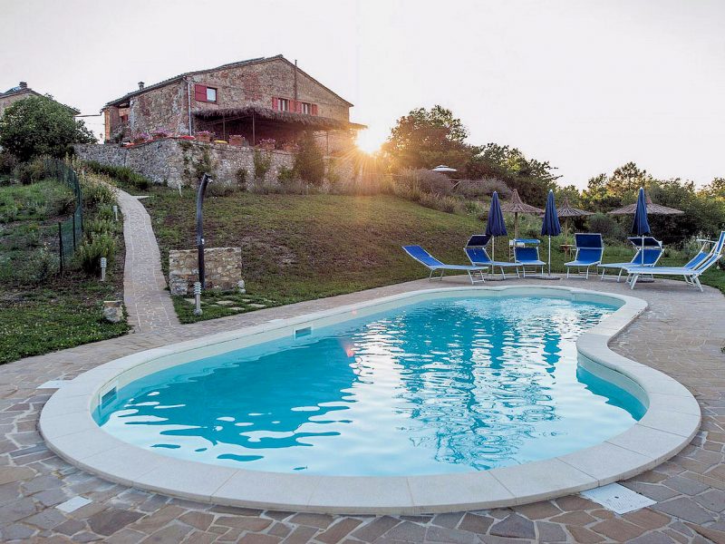 The estate's pool beckons guests during the heat of the Tuscan summer.