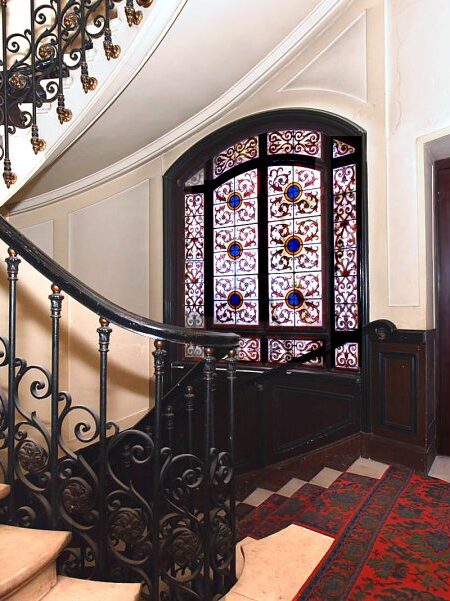 A small elevator is strategically placed near the apartment entry doors.