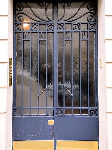 This code-operated secure entry door opens from a side street to access the stairway to the Place des Galeries apartment.