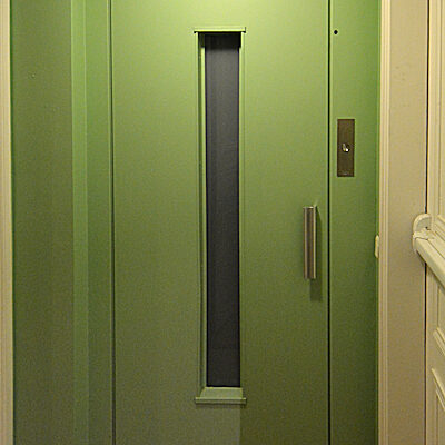 Small lift just outside the apartment entry door.