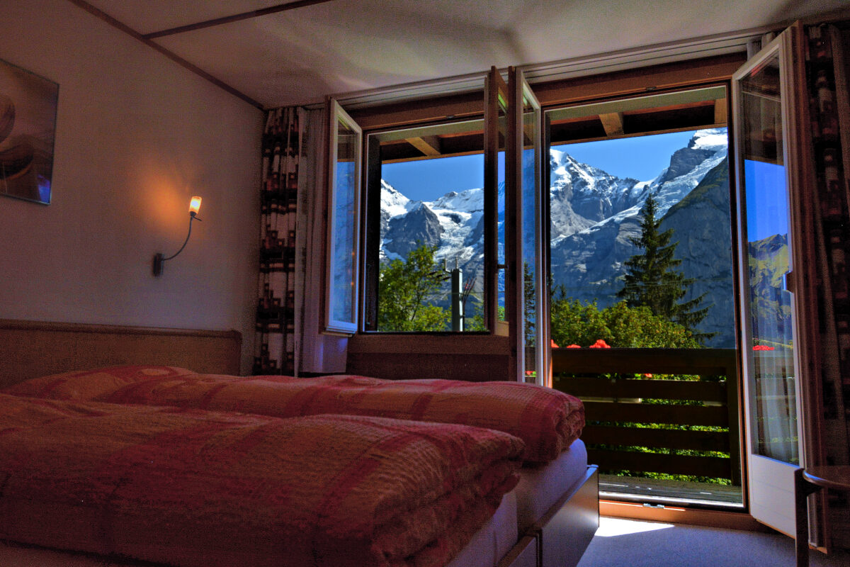 Chalet Eiger: 2nd floor 2-bedroom apartment - bedroom with balcony access. Photo © Home At First.