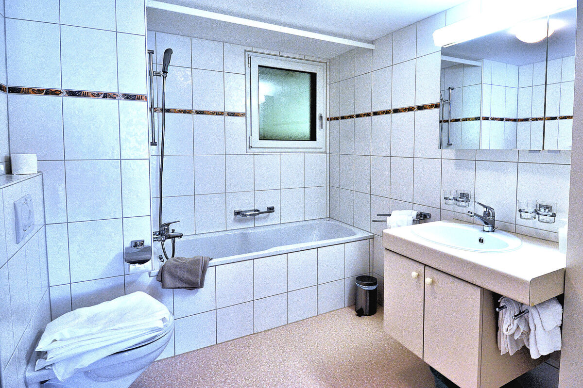 Chalet Eiger - Large apartment: 1 of 2 full bathrooms with tub-shower. Photo © Home At First.