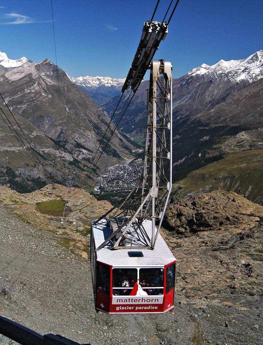 Klein Matterhorn cable car arrives at Trockener Steg high above Zermatt in the valley below.