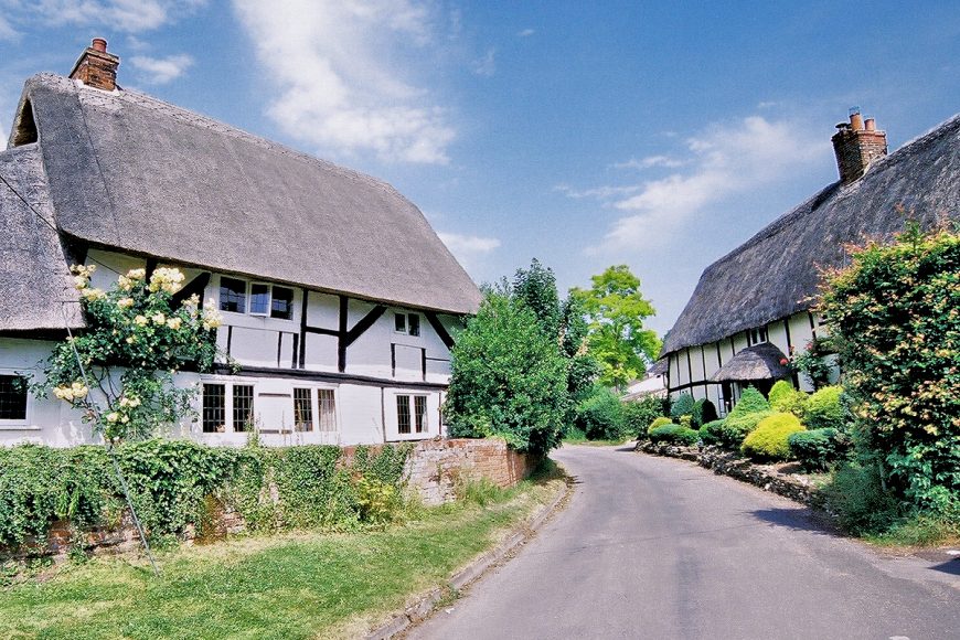 Wiltshire: B-road through a thatched hamlet. Photo copyright Home At First.