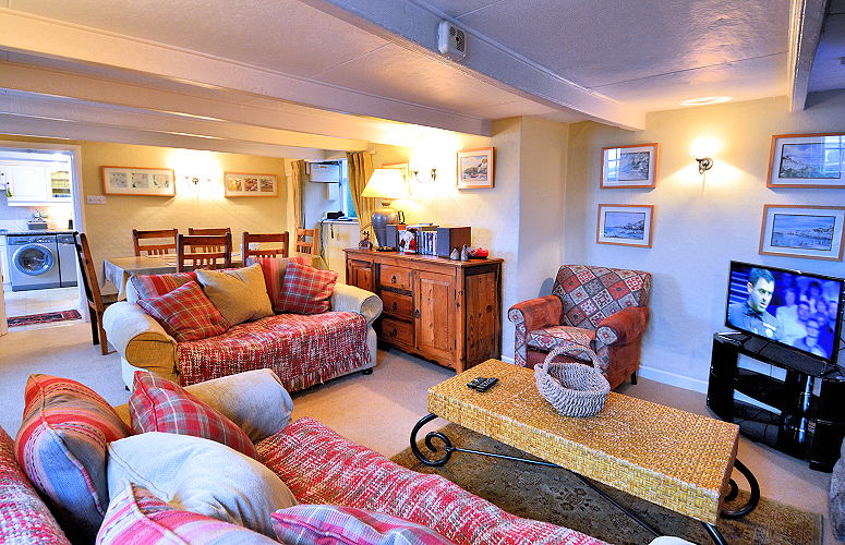 Coverack: Stone Thatched Cottage — Living room, dining room, and kitchen. Photo copyright Home At First.