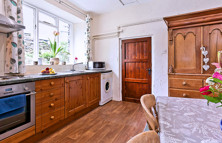 Hawkshead — Copper Cottage 2-bedroom, 2-bath: kitchen with dining area & washing machine. Photo courtesy the owners.