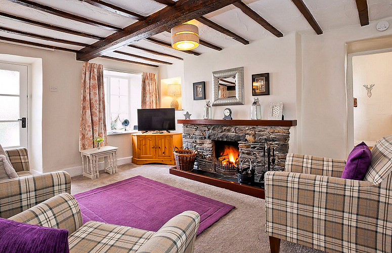 Hawkshead — Copper Cottage 2-bedroom, 2-bath: living room with TV and fire. Photo courtesy the owners.