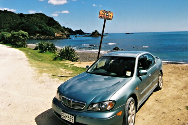 Rental car on the beach at Matauri Bay, Northland.