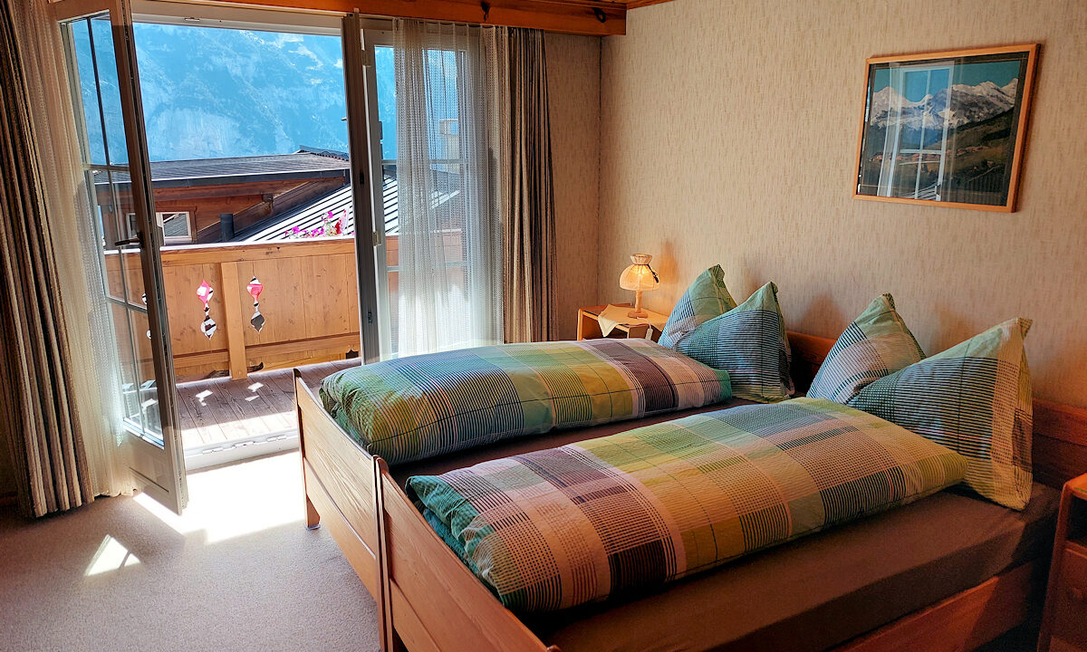 Chalet Silberhorn - Lower Apartment: Master Bedroom with Balcony access. Photo © Home At First.