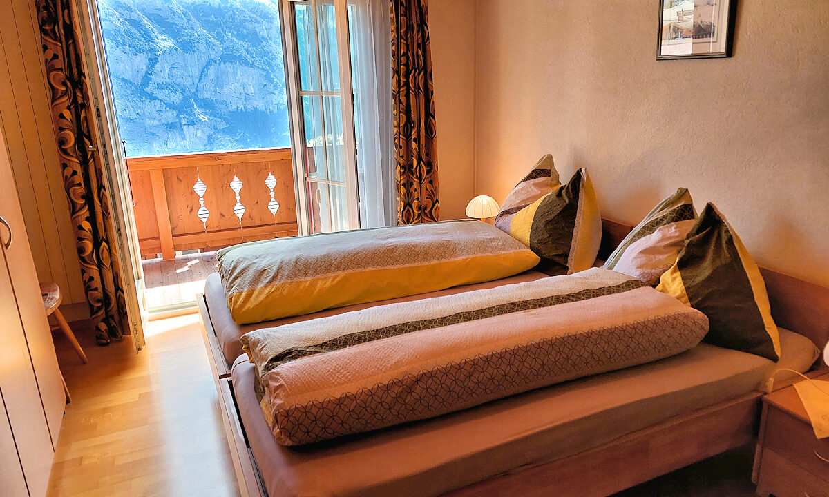 Chalet Silberhorn - Upper Apt. - Twin bedroom with Balcony View. Photo © Home At First.