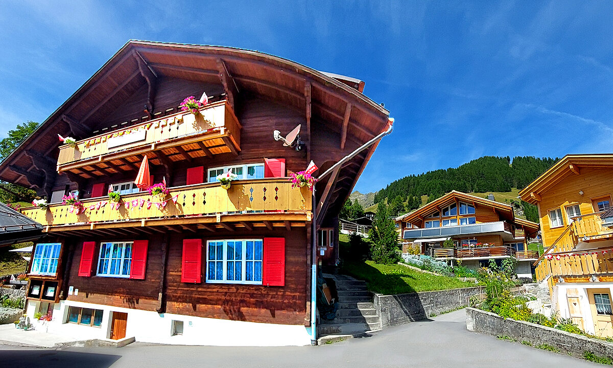 Chalet Silberhorn: front view with balconies and neighborhood. Photo © Home At First.